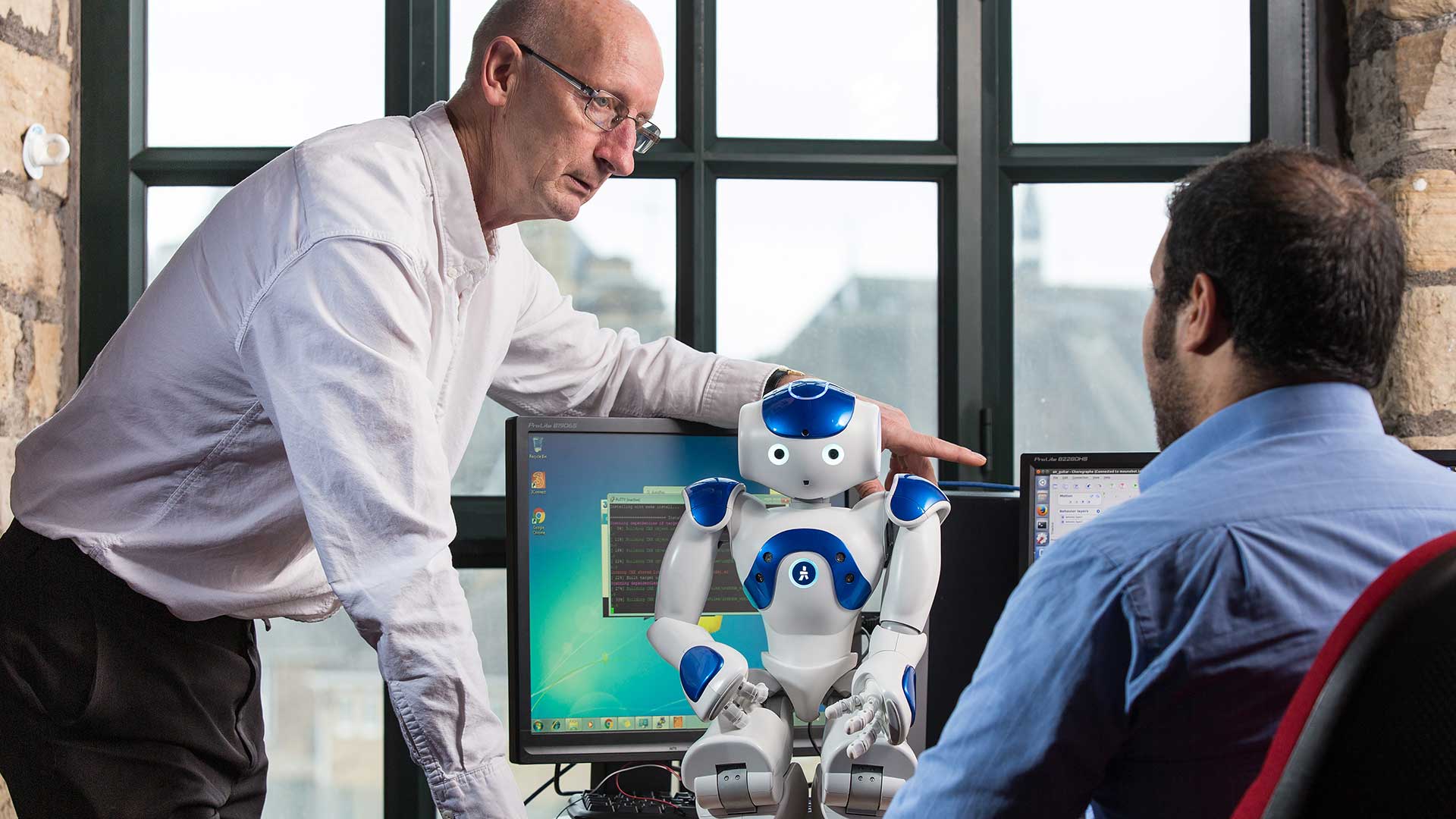 student and staff member with programmable robot