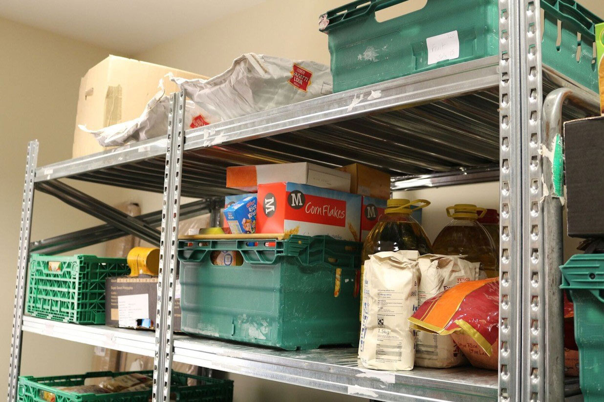Foodbank shelving including cereals, jars and cans of food